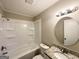 Bathroom with a shower-tub combo, granite-topped vanity, and modern lighting fixtures at 837 Needle Rock Dr, Stone Mountain, GA 30083