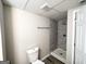 Well-lit bathroom features modern tile shower, neutral paint and newer fixtures at 837 Needle Rock Dr, Stone Mountain, GA 30083