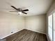 Cozy bedroom featuring a modern ceiling fan, light walls and wood flooring at 837 Needle Rock Dr, Stone Mountain, GA 30083