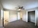 Bedroom boasting neutral paint, plush carpeting, and access to the closet and bathroom at 837 Needle Rock Dr, Stone Mountain, GA 30083