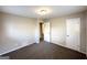 Bedroom with neutral paint, plush carpeting, and doors to the bathroom and closet at 837 Needle Rock Dr, Stone Mountain, GA 30083