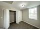 Bedroom with a window, closet, and neutral-colored walls and carpet at 837 Needle Rock Dr, Stone Mountain, GA 30083