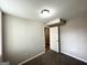 Bedroom featuring neutral paint, plush carpeting, and a partially opened closet at 837 Needle Rock Dr, Stone Mountain, GA 30083