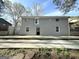 Back of a grey brick two-story home with black door and several windows at 837 Needle Rock Dr, Stone Mountain, GA 30083