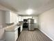 Bright kitchen with white cabinets, granite counters, and stainless steel appliances at 837 Needle Rock Dr, Stone Mountain, GA 30083
