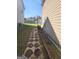 Landscaped backyard path with stone pavers between homes, offering a private and tranquil walkway at 3620 Pickeral St, Fairburn, GA 30213