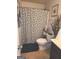 Bathroom featuring a toilet with decorative rug, shower curtain, and wall art at 3620 Pickeral St, Fairburn, GA 30213
