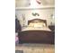 Well-lit bedroom with ceiling fan, wall decor, and a large bed with decorative pillows and bedding at 3620 Pickeral St, Fairburn, GA 30213
