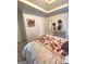 Bedroom showcasing a carpet, tray ceiling, and pleasant floral artwork at 3620 Pickeral St, Fairburn, GA 30213