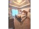 Relaxing bedroom featuring carpet, a decorative ceiling, and natural lighting at 3620 Pickeral St, Fairburn, GA 30213