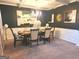 Elegant dining room featuring stylish decor, dark accent wall, and ample seating for gatherings at 3620 Pickeral St, Fairburn, GA 30213