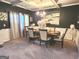 Elegant dining room bathed in natural light with a formal table setting and coffered ceilings at 3620 Pickeral St, Fairburn, GA 30213