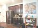 Well-lit kitchen with stainless steel appliances, dark wood cabinets and granite countertops at 3620 Pickeral St, Fairburn, GA 30213