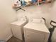 Functional laundry room featuring white washer and dryer units, ensuring efficient laundry care at 3620 Pickeral St, Fairburn, GA 30213