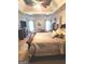 Spacious main bedroom featuring tray ceilings, large bed, sitting area, and plenty of natural light at 3620 Pickeral St, Fairburn, GA 30213