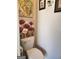 Neat powder room featuring painted floral artwork at 3620 Pickeral St, Fairburn, GA 30213