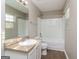A functional bathroom featuring a vanity with a mirror, standard toilet, and a shower-tub combination at 312 Silver Fox Trl, Dallas, GA 30157