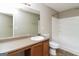 Well-lit bathroom featuring a vanity with countertop, framed mirror, and a standard shower-tub combination at 312 Silver Fox Trl, Dallas, GA 30157