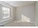 A light-filled room with neutral carpet and paint, brightened by a window featuring a charming window seat at 312 Silver Fox Trl, Dallas, GA 30157
