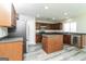 Modern kitchen with a kitchen island, stainless steel appliances and ample cabinet space at 312 Silver Fox Trl, Dallas, GA 30157