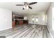 Open floor plan with new gray floors, a ceiling fan, double doors and a combined kitchen area at 312 Silver Fox Trl, Dallas, GA 30157