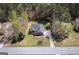 Expansive view of a home nestled among trees with a well-manicured lawn and long driveway at 50 Clear Spring Ct, Oxford, GA 30054