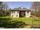 Fenced backyard with a spacious lawn and two-story home with screened porch at 50 Clear Spring Ct, Oxford, GA 30054