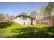 Large backyard with two-story home and chain-link fence at 50 Clear Spring Ct, Oxford, GA 30054