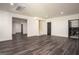 Finished basement with gray vinyl flooring, neutral paint and multiple entrances at 50 Clear Spring Ct, Oxford, GA 30054
