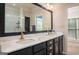 Bathroom featuring double sinks, marble countertops and a large mirror at 50 Clear Spring Ct, Oxford, GA 30054