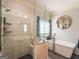 Bathroom showcasing marble tile, glass shower and soaking tub at 50 Clear Spring Ct, Oxford, GA 30054