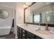 Bathroom featuring double sinks, marble countertops and soaking tub at 50 Clear Spring Ct, Oxford, GA 30054