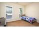 Bright bedroom features two windows and a bed with a playful football-themed comforter at 50 Clear Spring Ct, Oxford, GA 30054