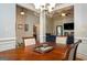 Dining area opens to living room, featuring a wooden table and views of the living space at 50 Clear Spring Ct, Oxford, GA 30054