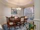 Traditional dining room featuring a wooden table, wainscoting, chandelier, and a large window for natural light at 50 Clear Spring Ct, Oxford, GA 30054