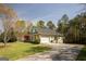 Home with a well-manicured lawn and a concrete driveway leading to an attached two-car garage at 50 Clear Spring Ct, Oxford, GA 30054