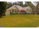 Traditional brick home surrounded by mature trees, offering a serene and inviting atmosphere at 50 Clear Spring Ct, Oxford, GA 30054