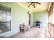 Inviting screened porch features overhead fan and outdoor grill at 50 Clear Spring Ct, Oxford, GA 30054