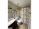Traditional bathroom features a shower-tub combo and a neutral-toned shower curtain at 2900 Haddon Dr, Rex, GA 30273