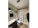 Cozy bathroom featuring a modern vanity, toilet, shower with curtain, and vinyl flooring at 2900 Haddon Dr, Rex, GA 30273