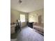 Bright Bedroom with a crib, changing table, desk, and carpeted floor at 2900 Haddon Dr, Rex, GA 30273