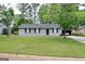 Charming home with manicured front lawn, mature trees and traditional landscaping at 2900 Haddon Dr, Rex, GA 30273