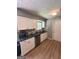 Stylish kitchen with stainless steel appliances, granite countertops, white cabinetry, and wood flooring at 2900 Haddon Dr, Rex, GA 30273