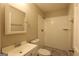 Bright bathroom featuring a vanity, toilet, and shower with subway tile and pebble floor at 3410 Nw Adkins Rd, Atlanta, GA 30331