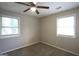Well-lit bedroom with neutral walls, carpet, and two windows providing plenty of natural light at 3410 Nw Adkins Rd, Atlanta, GA 30331