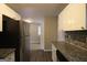 Well-lit kitchen showcasing granite countertops, stainless steel appliances, white cabinets and wood floors at 3410 Nw Adkins Rd, Atlanta, GA 30331