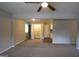 Open-concept living room with carpet, ceiling fan, laundry closet, and views of kitchen at 3410 Nw Adkins Rd, Atlanta, GA 30331