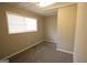 Cozy bedroom with neutral walls, plush carpet, and a bright window at 5960 John St, Austell, GA 30106