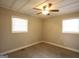 Well lit bedroom with a ceiling fan and two windows at 5960 John St, Austell, GA 30106