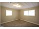 Inviting bedroom with two sunny windows and soft, neutral carpet at 5960 John St, Austell, GA 30106